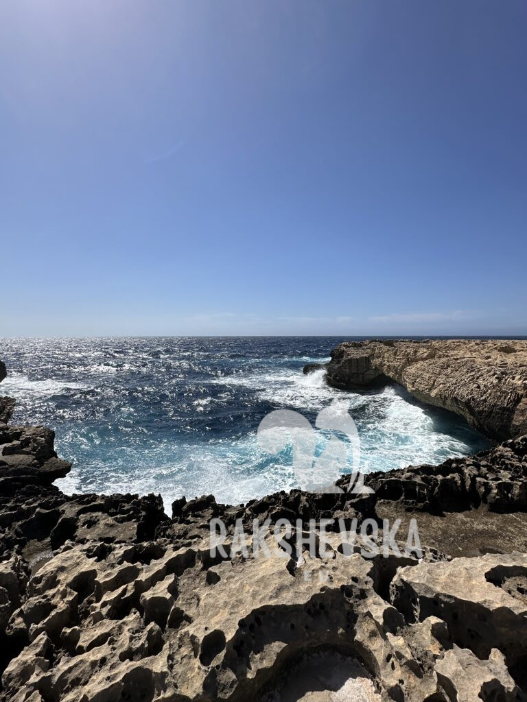 Jagged coastline and turquoise water crashing through natural pools